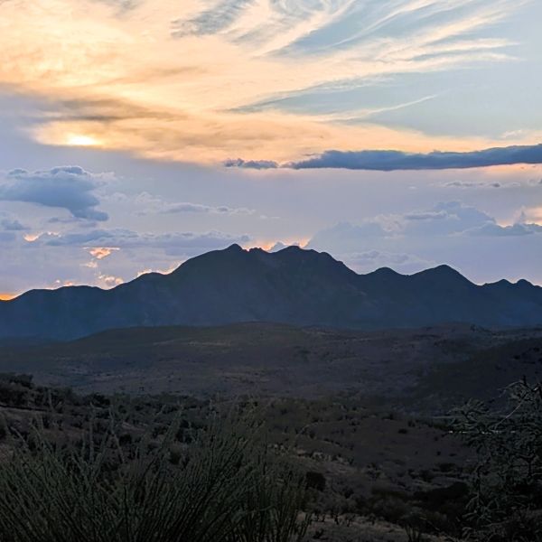 Desert landscape with mountains at sunset
